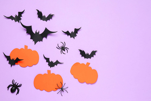 Flat lay composition with paper bats, spiders and pumpkins on light violet background, space for text. Halloween decor - Photo, Image