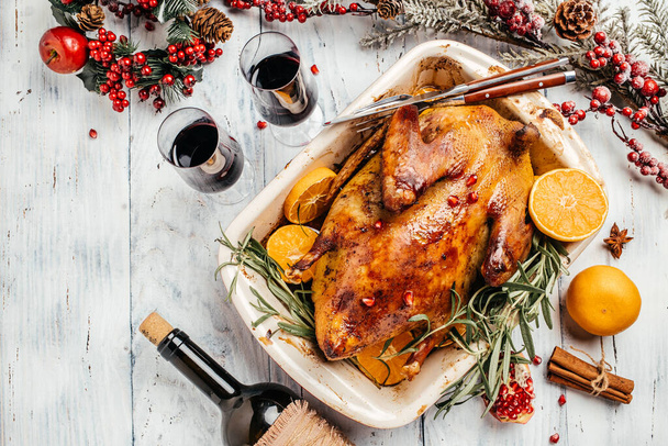 Roast duck with orange rosemary, and berries served on a festive table. Dish for Christmas Eve. banner, menu, recipe place for text, top view. - Foto, imagen