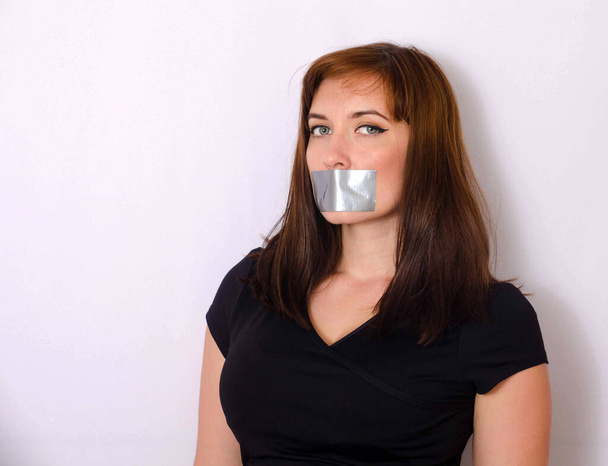 Young woman with taped mouth - Foto, Imagen