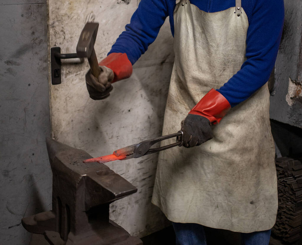 blacksmith forging with hammer blank metal part. High quality photo - Фото, зображення