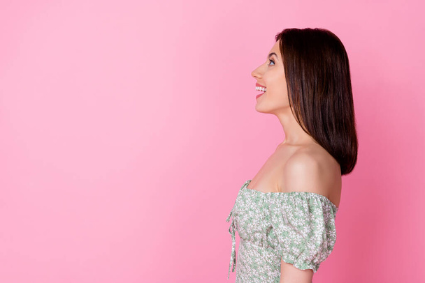 Profile photo of impressed millennial brunette lady look up wear dress isolated on pink color background. - Fotó, kép