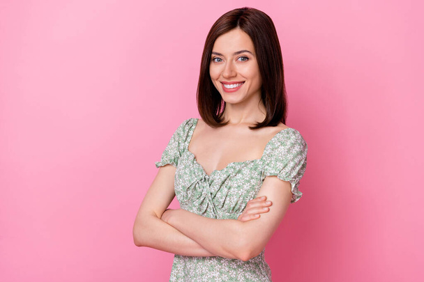 Photo of charming cheerful lady wear green clothes arms folded empty space isolated pink color background. - Foto, afbeelding