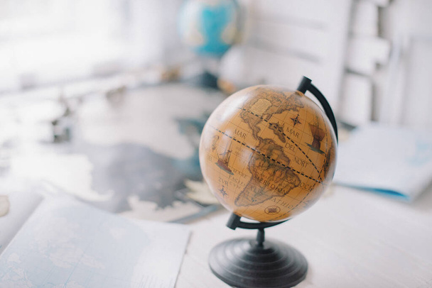 Brown globe on world map with blurred background. - Zdjęcie, obraz