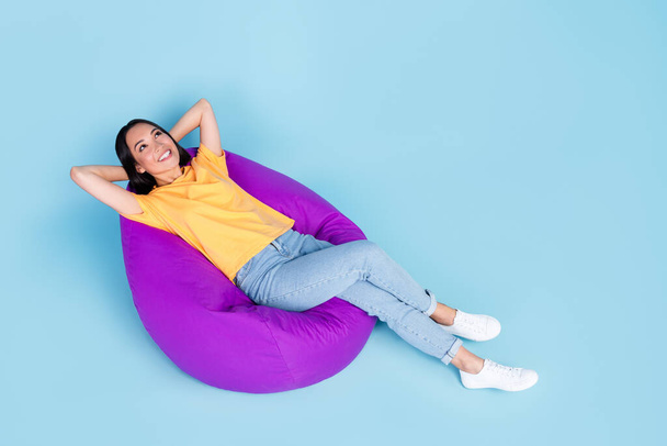 Full body photo high angle view of young girl japanese arms behind head relax wear trendy yellow garment isolated on blue color background. - Φωτογραφία, εικόνα