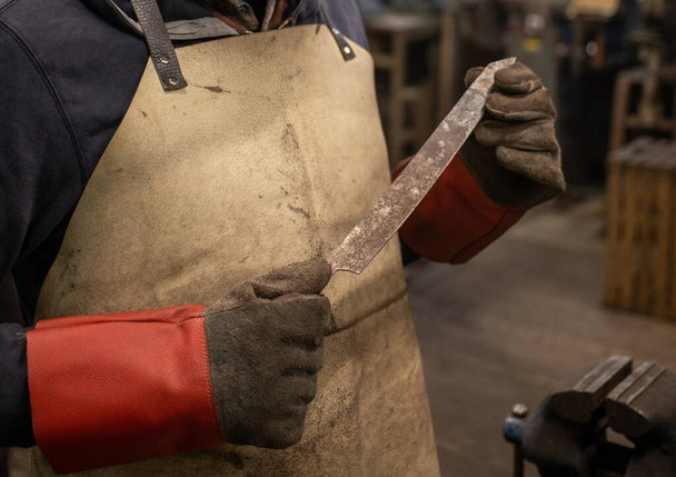 blacksmith forging with hammer blank metal part. High quality photo - Fotoğraf, Görsel