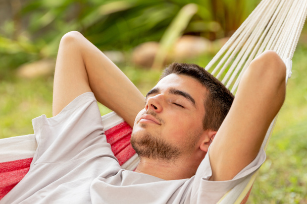 Młody człowiek śpi w hamaku latem - Zdjęcie, obraz