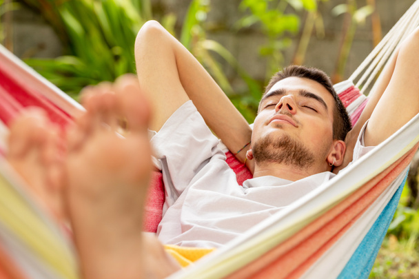 young man sleeping in the hammock in summer - Photo, Image
