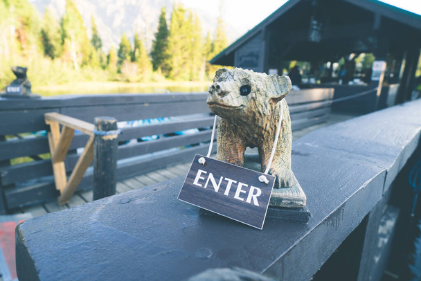 Wooden bear carving enter sign to enter a queue for a boat ride on a dock. Taken at Jenny Lake, Grand Teton National Park Wyoming - Photo, Image