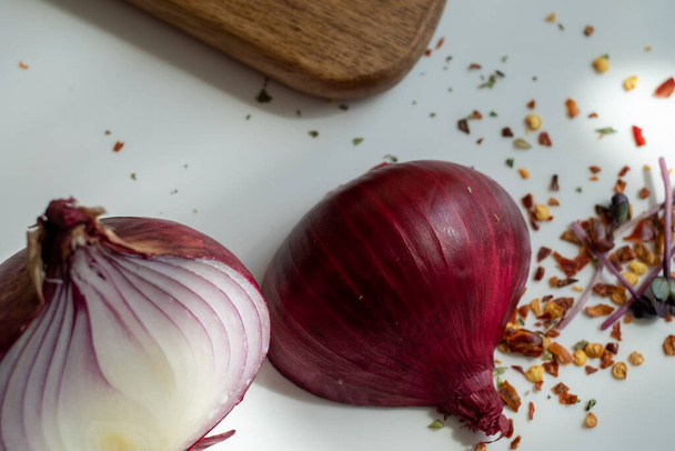 em uma mesa branca em um dia ensolarado de verão, duas metades de um onio vermelho - Foto, Imagem