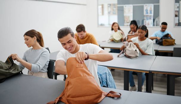 University students in a classroom, learning education at college in a diversity rich environment. Young men and women are excited to study and learn as they search for stationary in backpack - Foto, Imagem