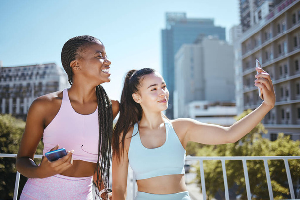 Fitness selfie, urban city and women friends or influencer for outdoor workout, motivation and training. Personal trainer or runner couple people taking photo together for social media wellness post. - Foto, Imagem