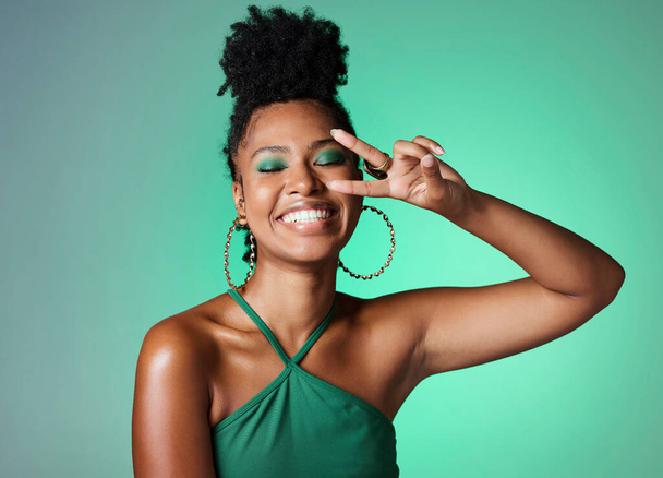 Peace sign hand, fashion and black woman on green studio background mockup with cosmetics and a bright smile. Happy african Kenya girl or model with color cosmetics and v sign for youth lifestyle. - Фото, зображення