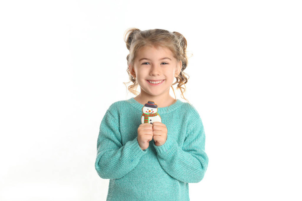 Cute little girl with Christmas gingerbread cookie on white background - 写真・画像