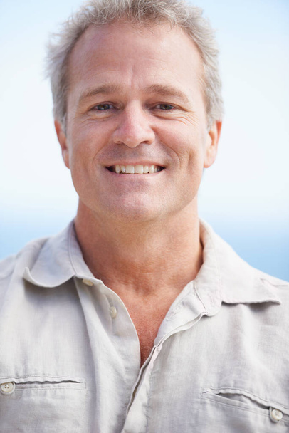 Enjoying some fresh sea air. Head and shoulders portrait of a mature man smiling happily at the camera - Photo, Image