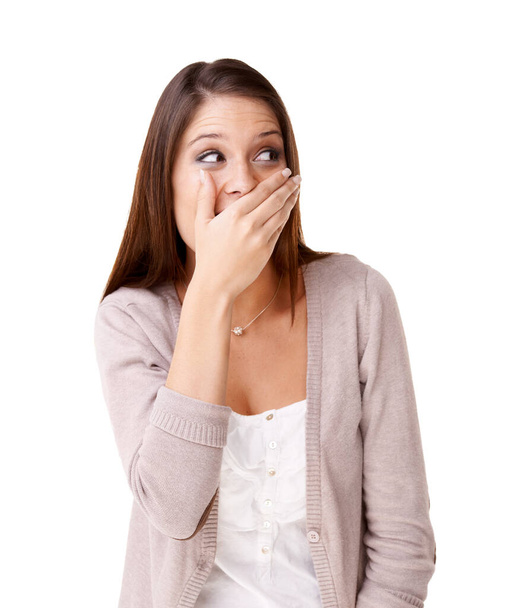 I cant believe she said that. Surprised young woman covering her mouth against a white background - Fotoğraf, Görsel