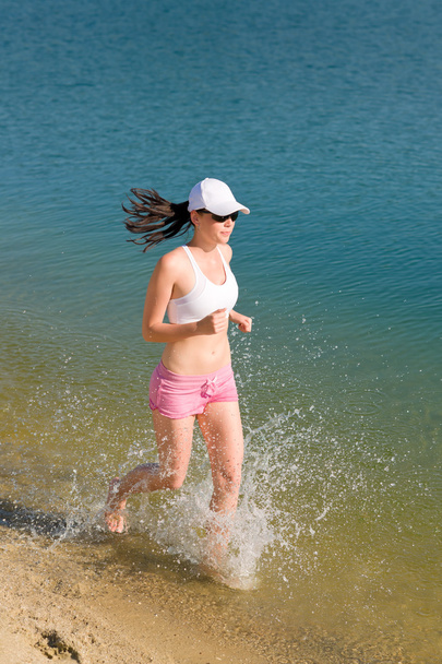 Summer sport fit woman jogging along seashore - Foto, Imagem