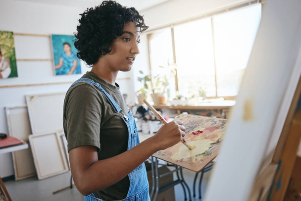 Paint, art and creative with a woman painter or artist working on a canvas in her workshop or studio. Artistic, creativity and artwork with a young female painting as a form or arts and crafts. - Photo, Image