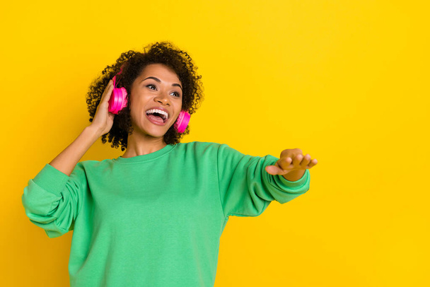 Portrait of overjoyed cool girl have fun listen favorite playlist isolated on yellow color background. - Foto, Imagem