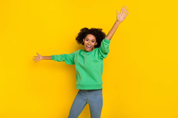 Photo of cool satisfied person raise opened arms have good mood isolated on yellow color background. - Photo, image