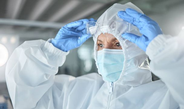 Covid, science ppe and innovation scientist with glasses and face mask safety for laboratory research, corona virus compliance investigation or test. Healthcare woman expert in hazmat suit for trust. - Fotografie, Obrázek