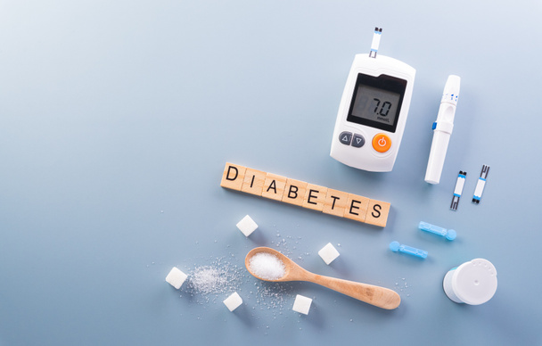 Healthcare and medical concept, Top view of blood glucose meter sets and stethoscope on pastel blue background. World Diabetes day, 14 November. - Photo, Image