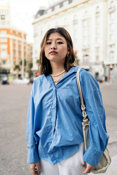 Pretty trendy asian woman posing and looking at camera in the city of Madrid. - Foto, Imagem
