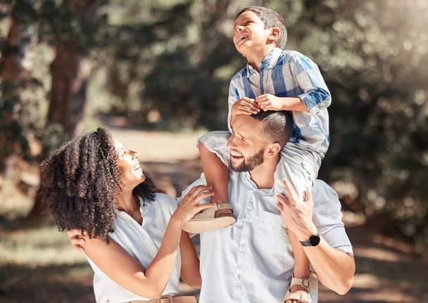 Love, relax and happy family laughing and bonding on outdoor walk in a park, cheerful and carefree. Playing, smiling and excited boy enjoying free time with his loving parents in nature on weekend. - Photo, Image
