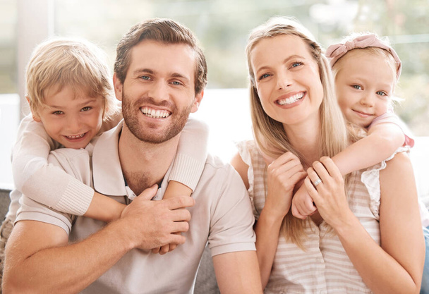 Happy family, father and mother portrait with children relaxing, hugging and enjoying fun quality time at home. Smile, mom and dad love bonding with young kids or boy and girl siblings affection. - Foto, Bild