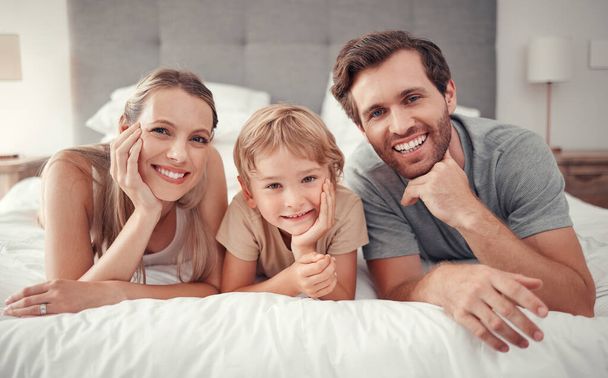 Love, bed and portrait of relax happy family with smile, happiness and enjoy quality time together in Australia hotel bedroom. Holiday, vacation and bonding for group of people, parents and kid child. - Foto, afbeelding