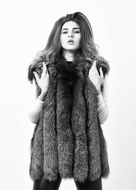 Fashion trend winter clothes. Boutique luxury fur. Winter fashion concept. Silver fur vest fashionable clothing. Luxury furry accessory. Girl makeup face long hairstyle wear fur vest white background. - Foto, afbeelding