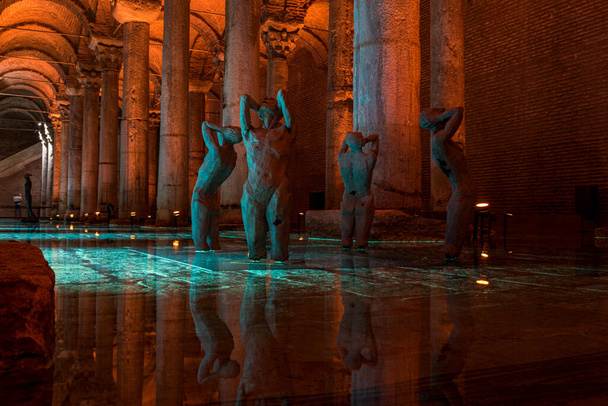 Yerebatan Sarayi - Basilica Cistern is one of favorite tourist attraction in Istanbul. Noise and grain include. Selective focus statue and sculptures - Photo, Image