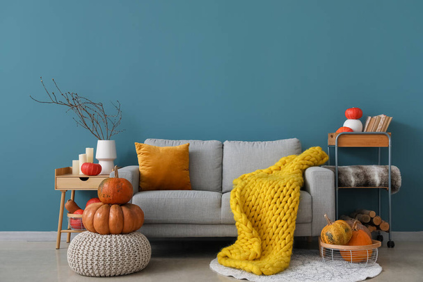 Interior of cozy living room with pumpkins, sofa and pouf - Photo, Image