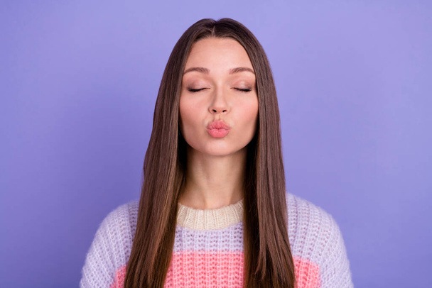 Photo of gorgeous beautiful stunning woman with long hairdo dressed striped jumper send kiss in air isolated on purple color background. - Foto, afbeelding