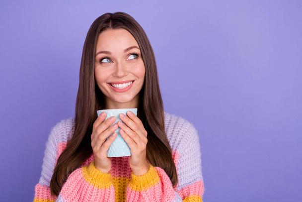 Photo of gorgeous cute girl with long hairstyle wear colored sweater hold cup look empty space isolated on purple color background. - Fotoğraf, Görsel