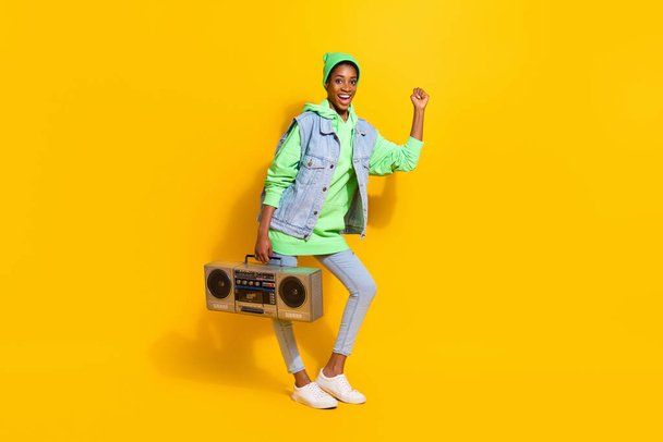 Full size photo of carefree overjoyed girl hold vintage cassette recorder dancing isolated on yellow color background. - Fotografie, Obrázek