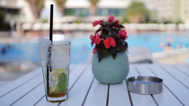 Lemonade and soft drinks in glass with ice. Summer cocktails drink on table by pool - Foto, Imagem