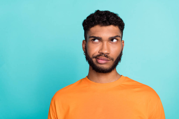 Close up photo of minded man wear trendy orange clothes look empty space idea plan hmm hard decision isolated on cyan color background. - Fotó, kép
