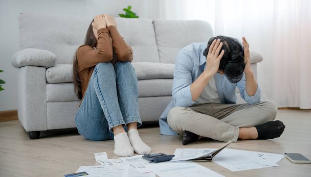 Asian couples managing debt and expenses. Husband and wife stressed over credit card bills and home electricity bills. Broke, mortgage, loan, bankruptcy, no money, bankruptcy, can't pay - Photo, Image