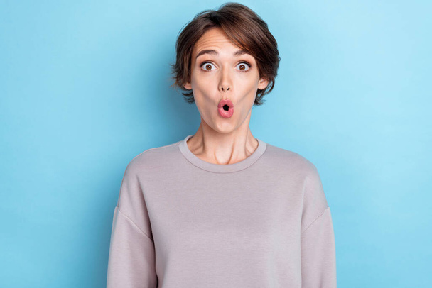 Photo of cute gorgeous pretty girl bob hairstyle gray sweatshirt staring at unbelievable sale banner isolated on blue color background. - Фото, зображення