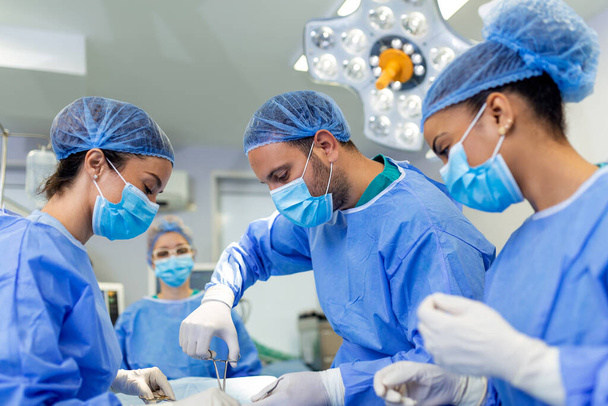 Doctor and assistant nurse operating for help patient from dangerous emergency case .Surgical instruments on the sterile table in the emergency operation room in the hospital.Health care and Medical - Photo, Image