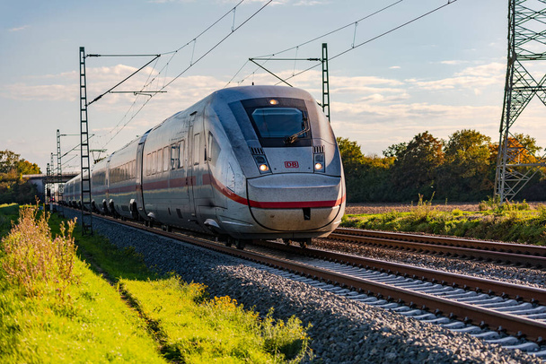Una linea ferroviaria con un treno ICE che attraversa la zona rurale, Germania - Foto, immagini