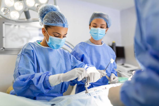 Another surgery. Surgery medical team operating in a surgery room of the hospital mature surgeon leading an operation profession professionalism occupation teamwork medical people doctors concept - Photo, image