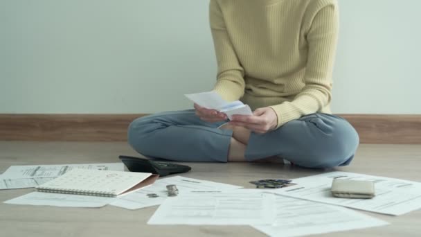 Debt and financial problems. woman  is sitting at the press of various expense calculators on invoices and credit card debt. woman are stressed with the debt to pay monthly. - Footage, Video