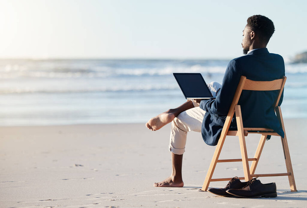 Beach vacation, work travel and black man doing business on holiday reading an email with 5g internet while working by ocean. Relax, break and happy African male doing remote work on a chair in Bali. - Photo, Image