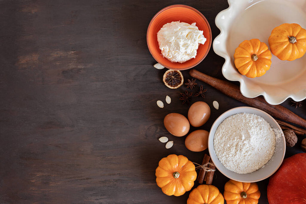 Fall pie baking ingredients with pumpkins, nuts, seasonal spices and tools. Pumpkin pie recipe idea. Thanksgiving and autumn holidays celebration concept. Top view, flatlay - Photo, Image