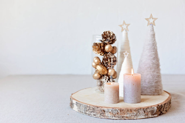Christmas table decoration with candles and handmade minimalist christmas trees. Festive interior design, easy and cheap diy centerpiece idea. - Foto, Imagem