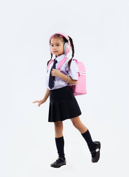 Back to school, junior school student in uniform with pink school bag posing on white background. - 写真・画像