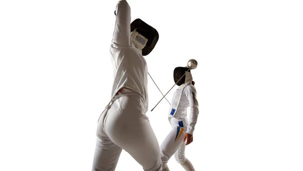 Two female fencing athletes fight isolated on white - Foto, Imagen