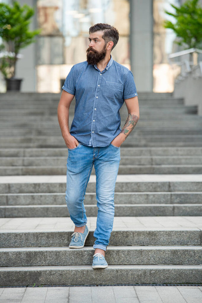 bearded hipster walk downstairs. full length of hipster with beard. hipster man outdoor. - Photo, Image