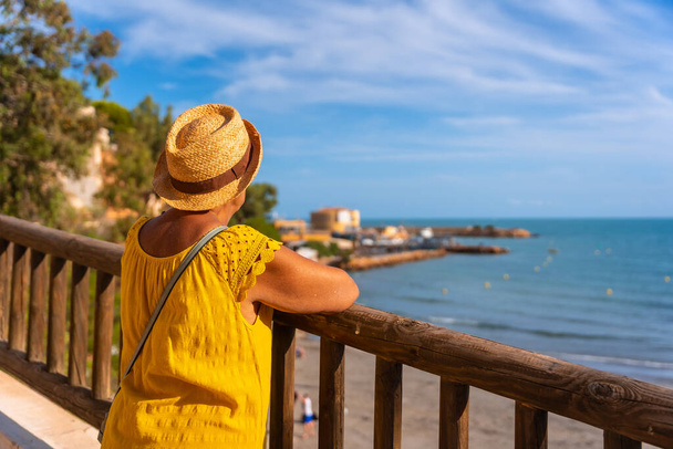 Elderly lady looking at the sea beach of La Caleta in Cabo Roig. Alicante. senior travel - Fotó, kép